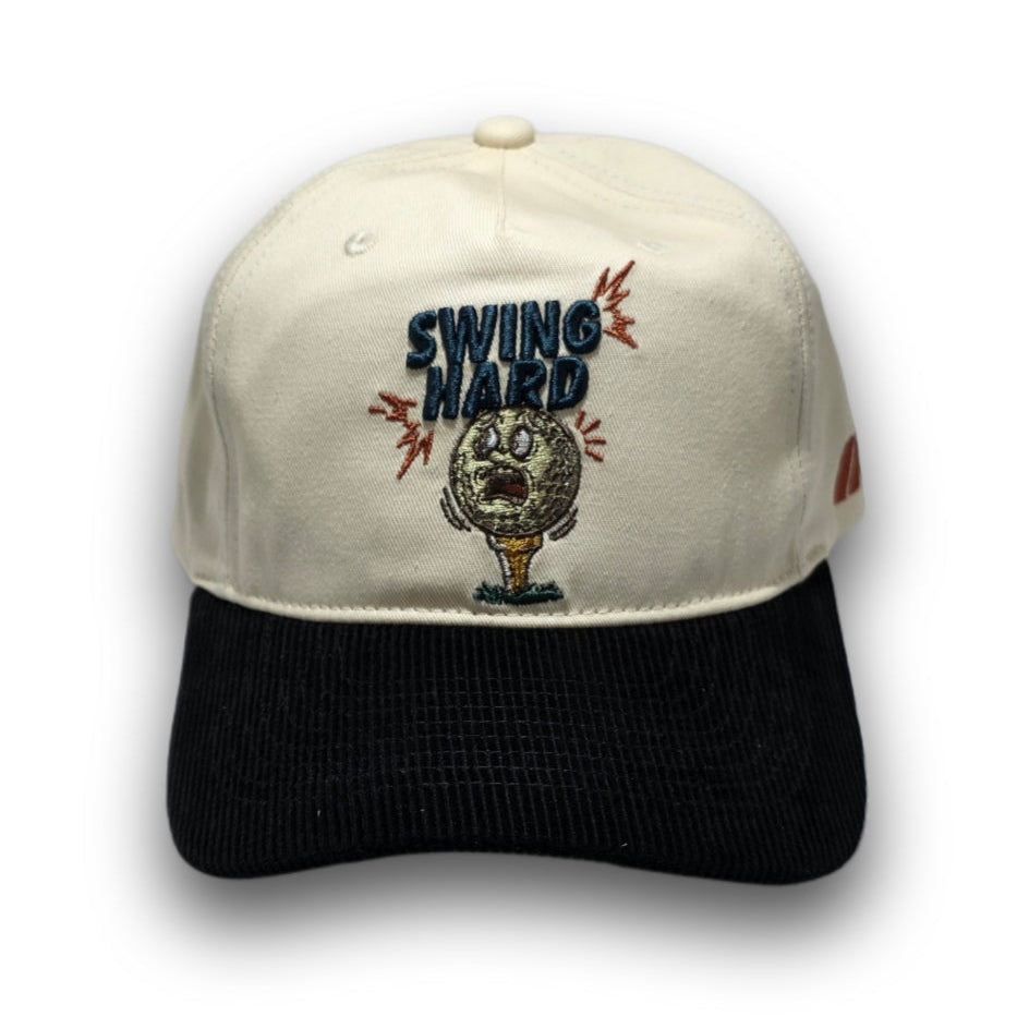 Front view of beige and black Swing Hard golf hat