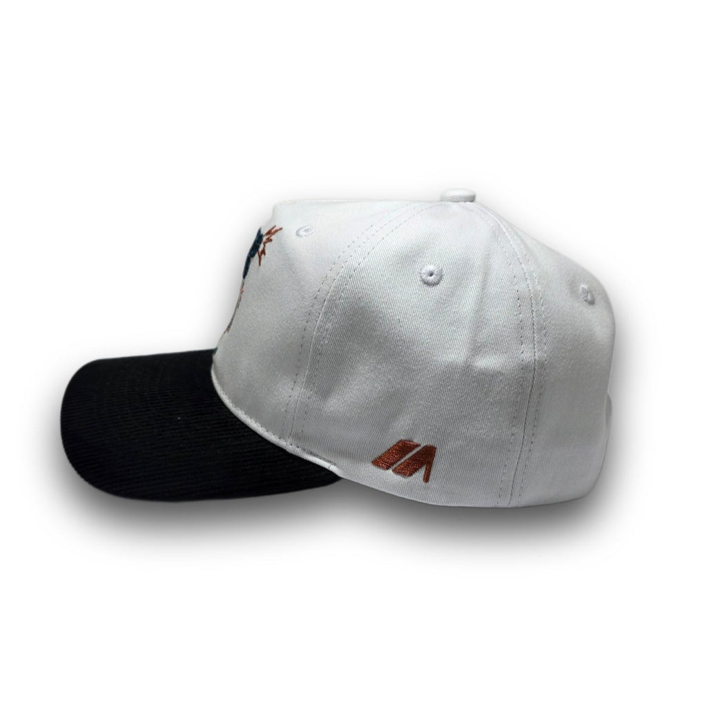 Side profile of white and black vintage golf hat with corduroy visor
