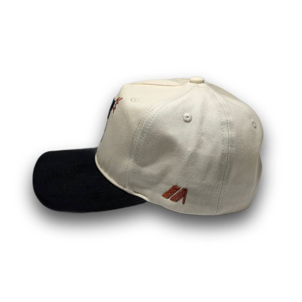 Side profile of beige and black vintage golf hat with corduroy visor