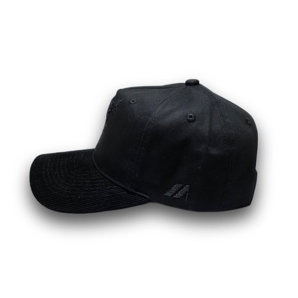 Side profile of tonal black vintage golf hat with corduroy visor